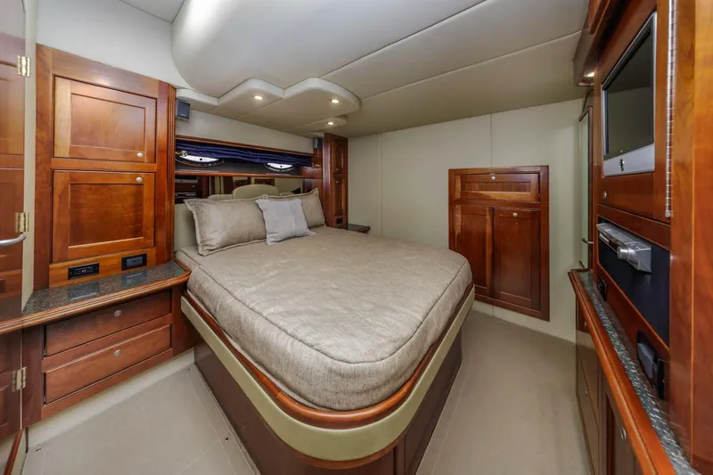 Slide: The Image of Luxurious cabin interior of 2007 Cruisers Yachts 560 Express with elegant wood finishes. - 26