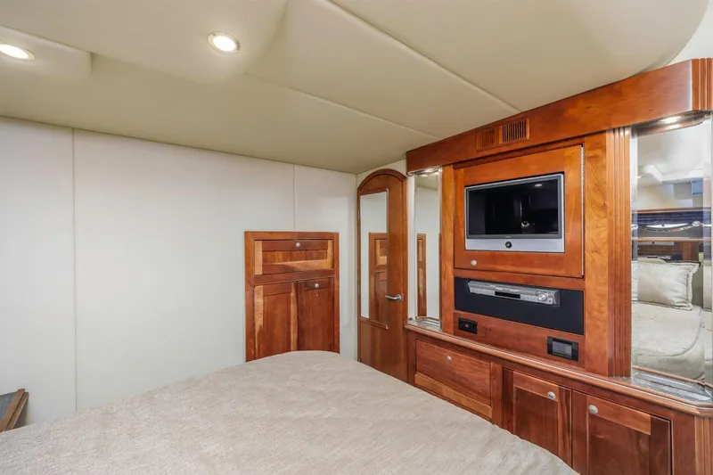 Slide: The Image of Luxurious 2007 Cruisers Yachts 560 Express interior with wood cabinetry and built-in entertainment system. - 27