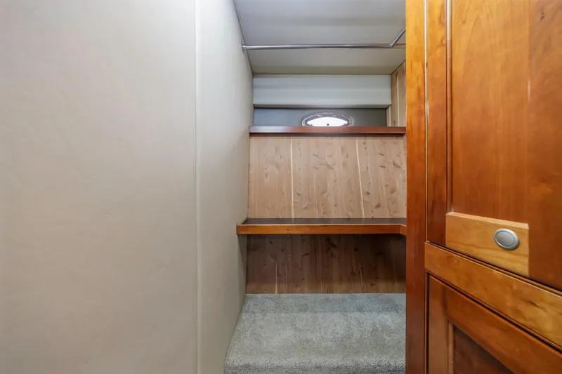 Slide: The Image of Interior view of 2007 Cruisers Yachts 560 Express, featuring wooden cabinetry and carpeted steps. - 28