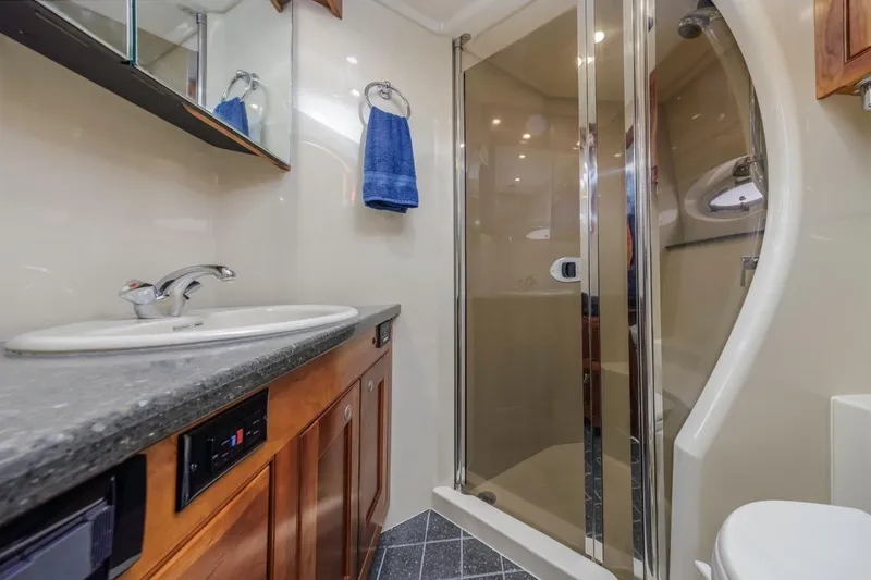 Slide: The Image of Luxurious bathroom in 2007 Cruisers Yachts 560 Express with modern fixtures and shower. - 29