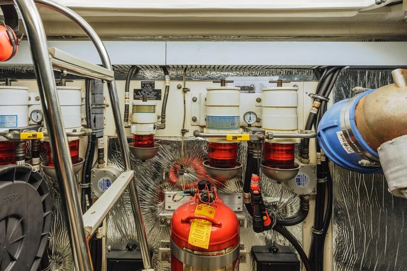 Slide: The Image of Engine room of 2007 Cruisers Yachts 560 Express, featuring fuel filters and fire extinguisher. - 31