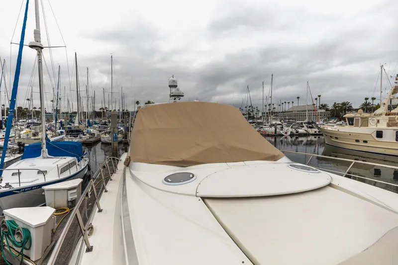 Slide: The Image of 2007 Cruisers Yachts 560 Express docked in a marina with overcast skies. - 39