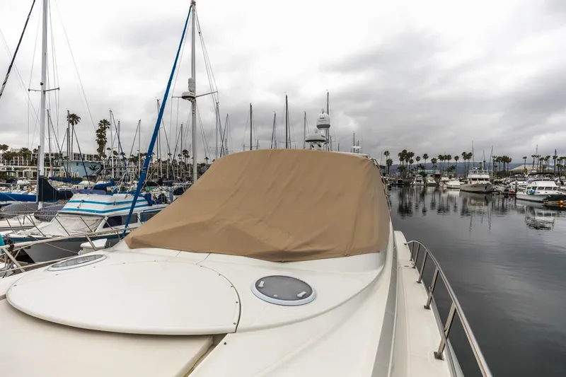 Slide: The Image of 2007 Cruisers Yachts 560 Express docked in a marina under cloudy skies. - 41