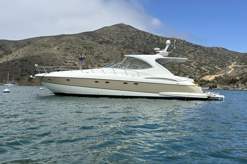 Slide: The Image of 2007 Cruisers Yachts 560 Express anchored in scenic bay with mountainous backdrop. - 6