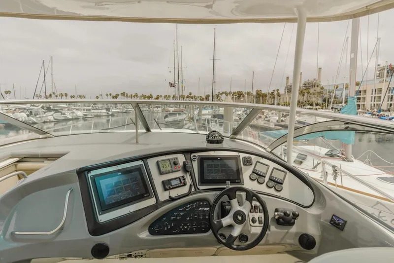 Slide: The Image of Helm of 2007 Cruisers Yachts 560 Express with marina view in background. - 7