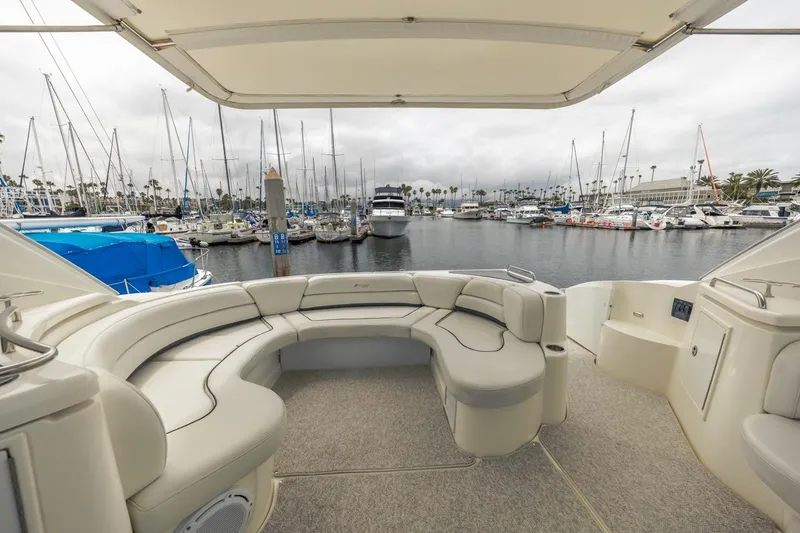 Slide: The Image of 2007 Cruisers Yachts 560 Express interior with marina view, featuring luxurious seating and elegant design. - 9