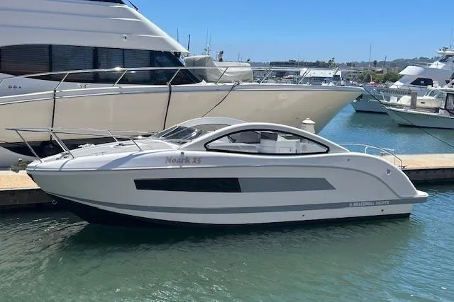 Slide: The Image of 2024 Bracewell 25 yacht docked in marina, sleek design, sunny day. - 2