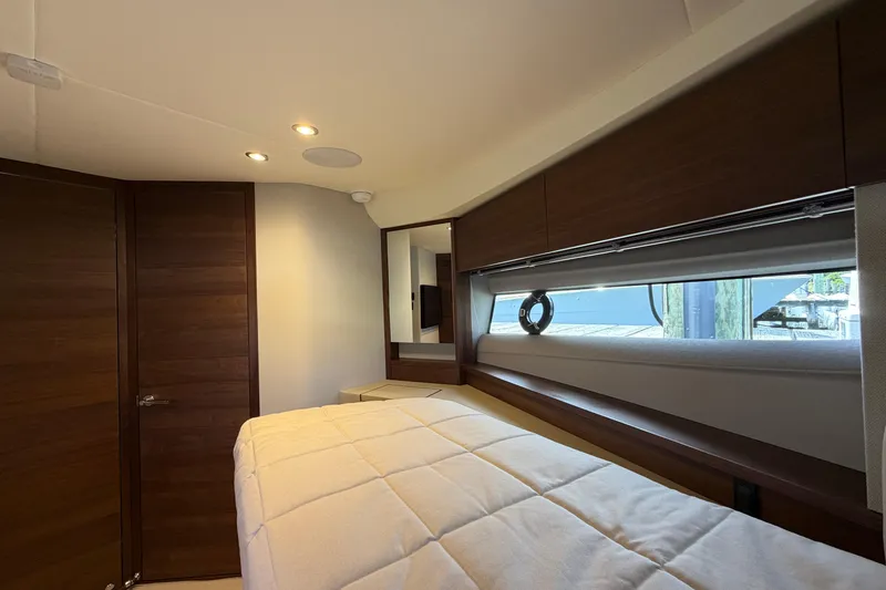 Slide: The Image of Luxurious cabin interior of 2027 Princess F50 yacht with modern wood finishes and cozy bedding. - 100