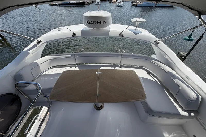 Slide: The Image of Luxurious 2027 Princess F50 yacht deck with seating and table, overlooking serene waters. - 51