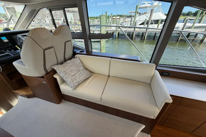 Slide: The Image of Luxurious interior of 2027 Princess F50 yacht with plush seating and scenic marina view. - 83