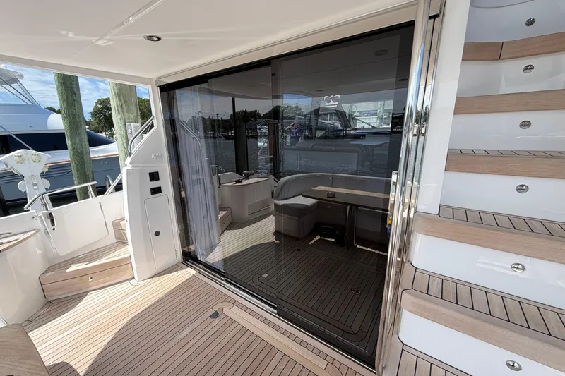 Slide: The Image of Luxury yacht Princess F50 2027 interior with wooden deck and modern seating area. - 64