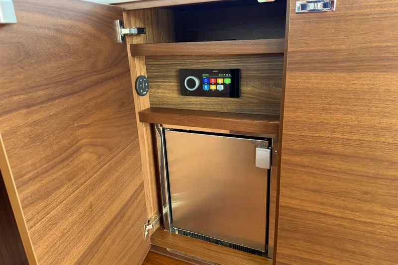 Slide: The Image of Wooden cabinet with a built-in control panel and compact fridge, Princess F50 2027 model. - 79