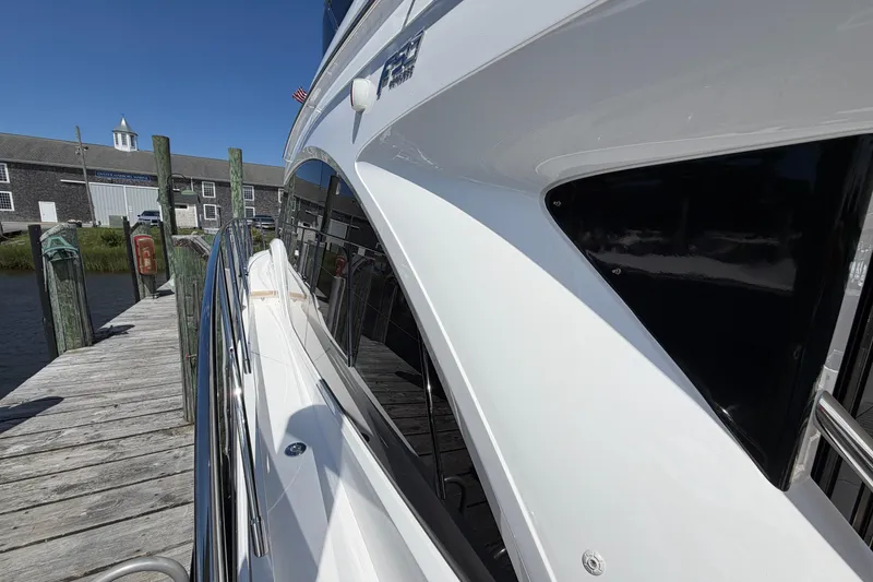 Slide: The Image of Side view of a sleek 2027 Princess F50 yacht docked at a marina. - 39