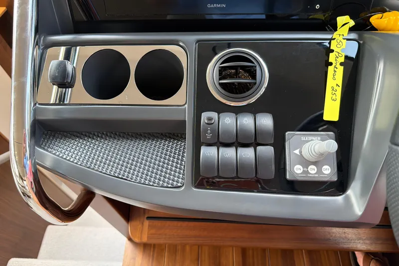 Slide: The Image of Control panel of a 2027 Princess F50 yacht with switches and cup holders. - 93