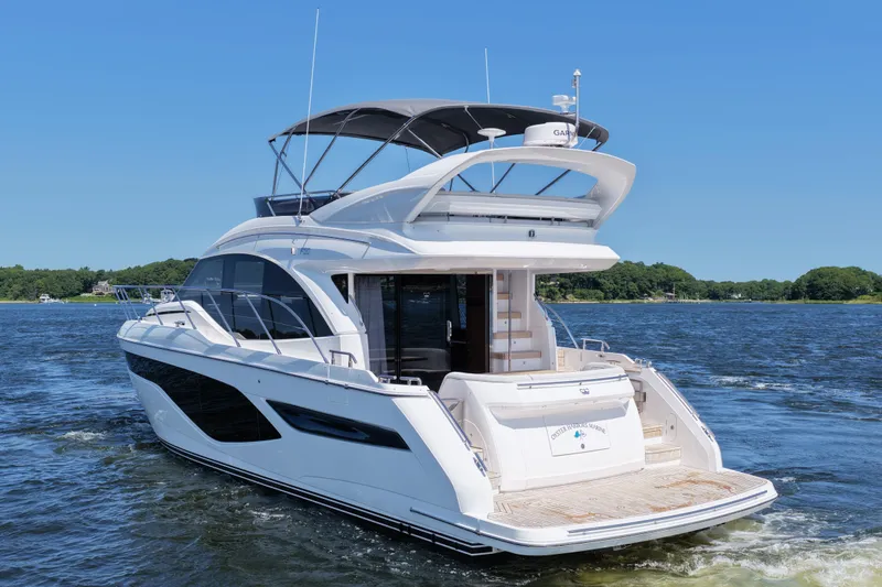 Slide: The Image of Luxurious 2027 Princess F50 yacht cruising on a serene lake under clear blue skies. - 8