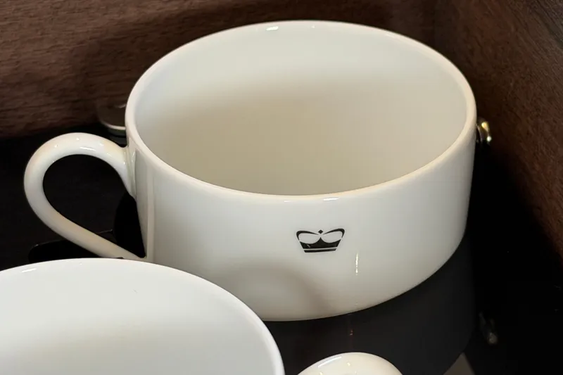 Slide: The Image of White ceramic cup with a crown logo, Princess F50 model, 2027. - 77