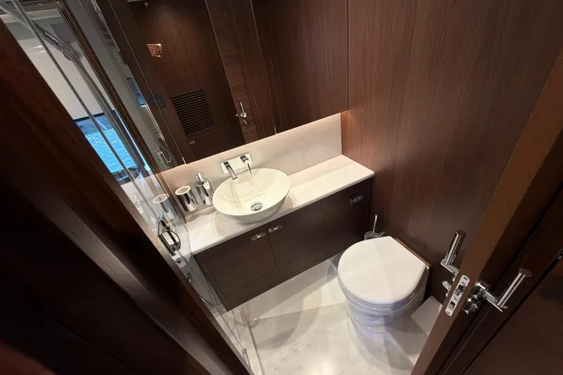 Slide: The Image of Luxurious bathroom in 2027 Princess F50 yacht with modern fixtures and wood paneling. - 125