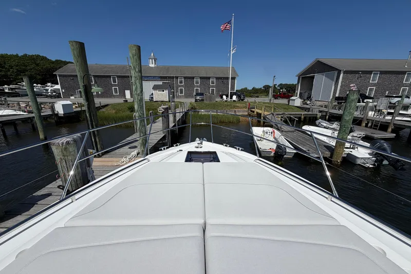 Slide: The Image of Bow view of 2027 Princess F50 yacht docked at a marina under clear blue skies. - 40