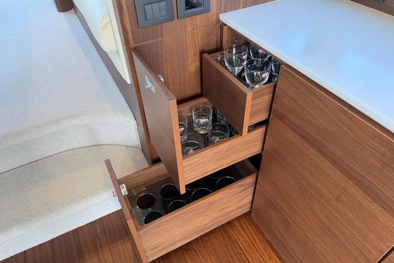 Slide: The Image of Luxury yacht Princess F50 2027 interior with wooden drawers storing glassware. - 80