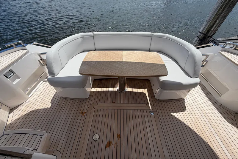 Slide: The Image of Luxurious seating area on 2027 Princess F50 yacht with wooden table and water view. - 28