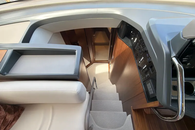 Slide: The Image of Interior view of 2027 Princess F50 yacht, featuring elegant stairs and modern control panel. - 94