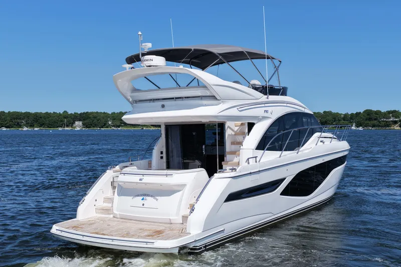Slide: The Image of Luxurious 2027 Princess F50 yacht cruising on a serene blue lake under clear skies. - 10