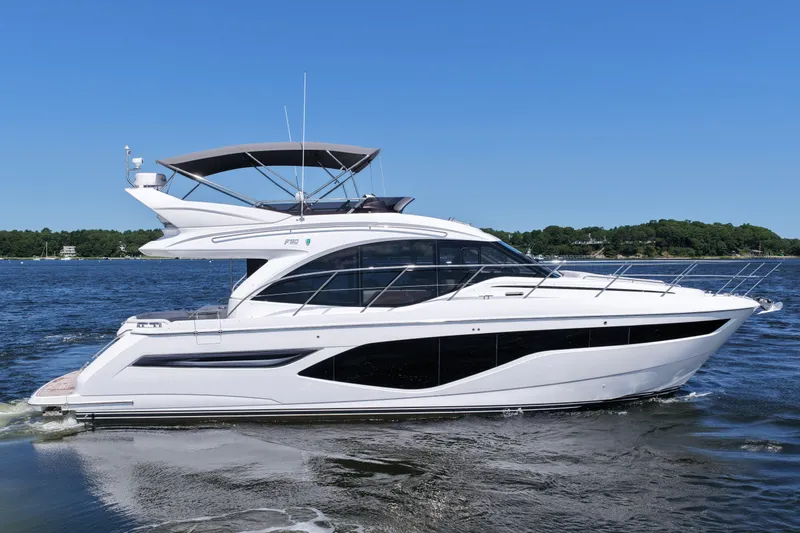 Slide: The Image of Luxury 2027 Princess F50 yacht cruising on a serene blue lake. - 12