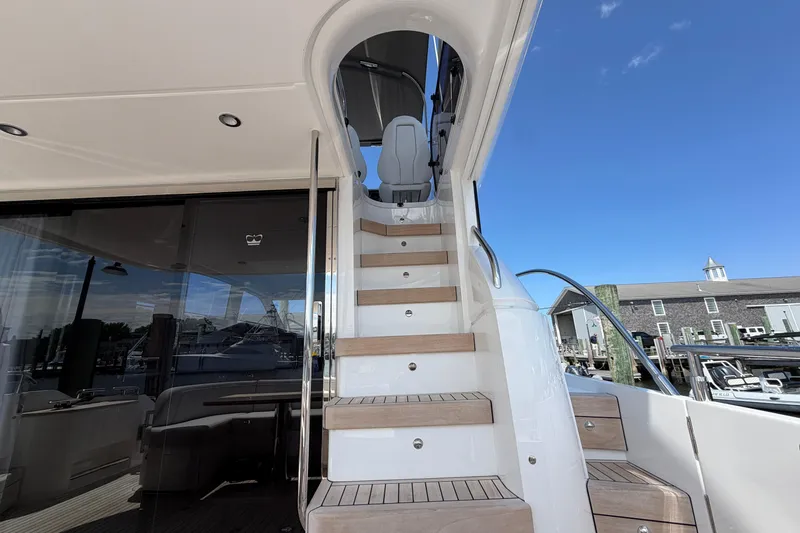 Slide: The Image of Staircase on 2027 Princess F50 yacht, leading to upper deck under clear blue sky. - 48