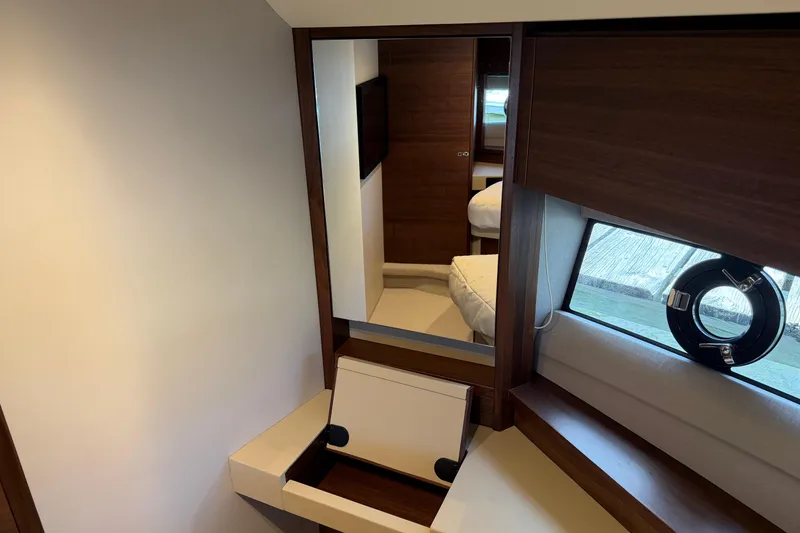 Slide: The Image of Interior of 2027 Princess F50 yacht with mirror, window, and wooden accents. - 101