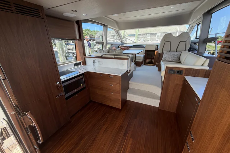 Slide: The Image of Luxurious interior of a 2027 Princess F50 yacht with modern kitchen and seating area. - 69