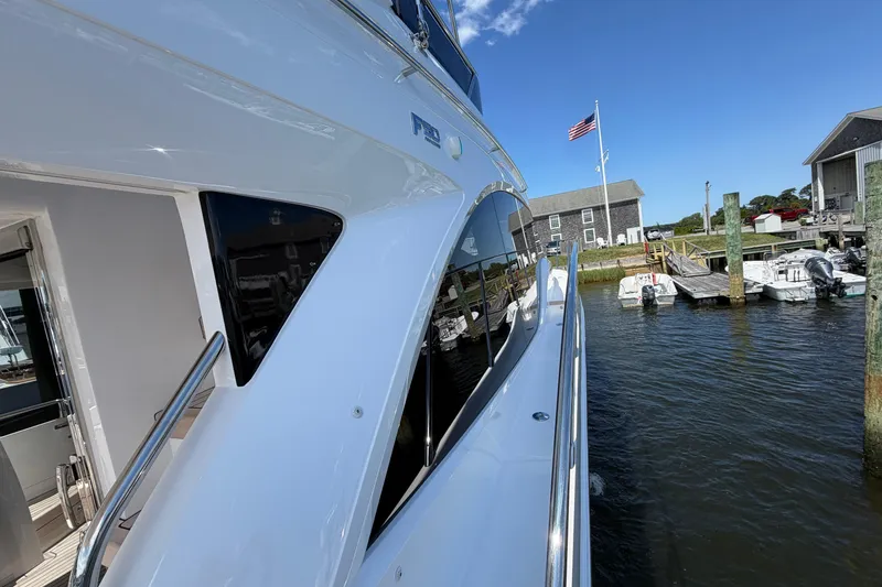 Slide: The Image of Modern 2027 Princess F50 yacht docked at a marina under a clear blue sky. - 38
