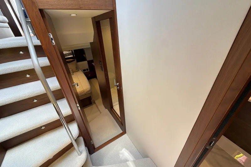Slide: The Image of Luxurious interior of 2027 Princess F50 yacht, featuring elegant stairs and cozy bedroom. - 109