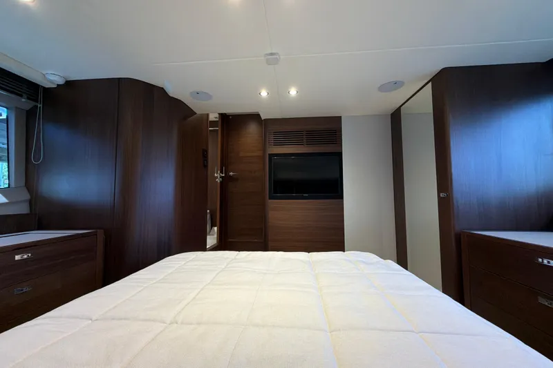 Slide: The Image of Luxurious cabin interior of 2027 Princess F50 yacht with modern wood finishes and cozy bedding. - 121