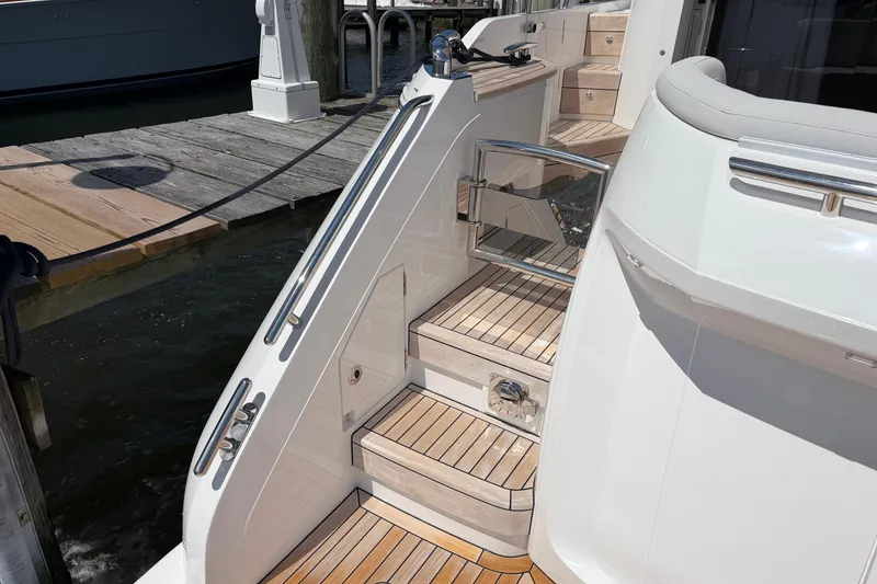 Slide: The Image of Staircase on a 2027 Princess F50 yacht with teak decking by a dock. - 22