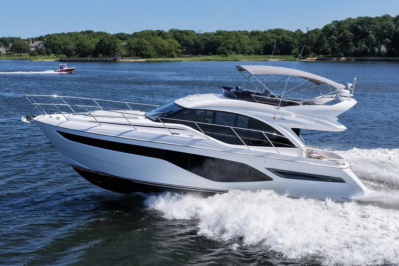 The Image of 2027 Princess F50 yacht cruising on a scenic waterway with lush greenery. - 0