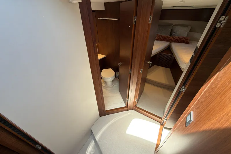 Slide: The Image of Luxurious interior of 2027 Princess F50 yacht featuring a cozy bedroom and modern bathroom. - 96