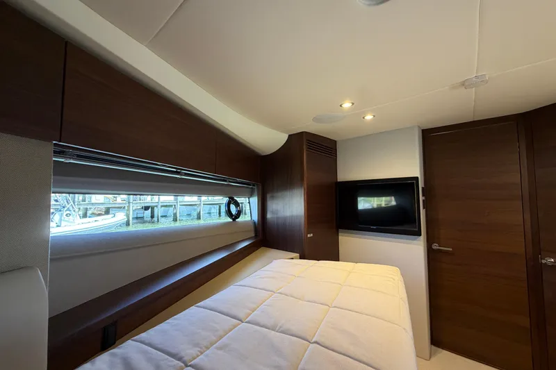 Slide: The Image of Luxurious cabin interior of 2027 Princess F50 yacht with modern wood finishes and window view. - 99
