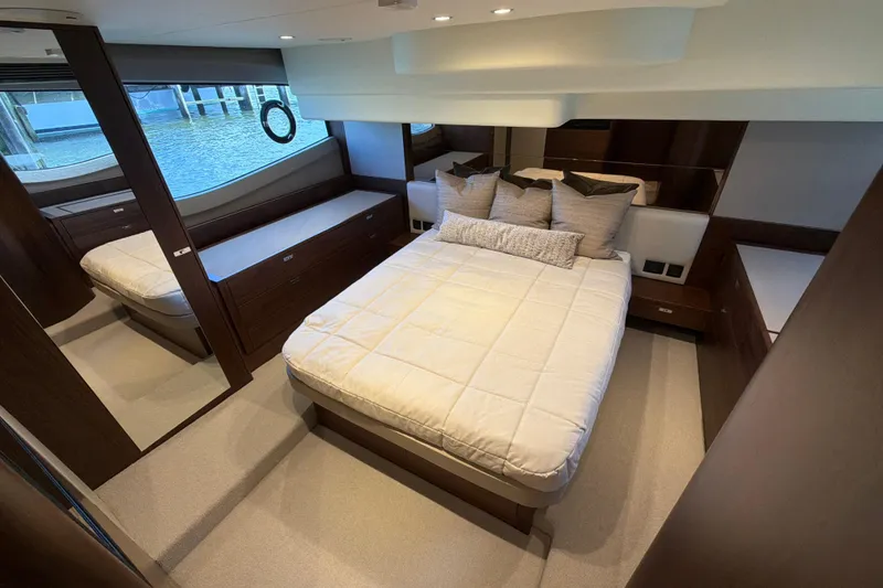 Slide: The Image of Luxurious cabin interior of 2027 Princess F50 yacht with elegant bedding and wood finishes. - 112