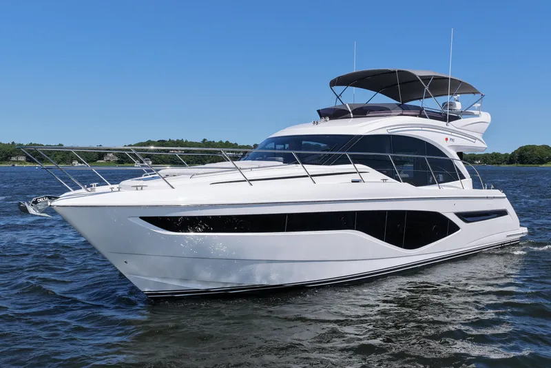 Slide: The Image of Luxurious 2027 Princess F50 yacht cruising on a serene waterway under a clear blue sky. - 5