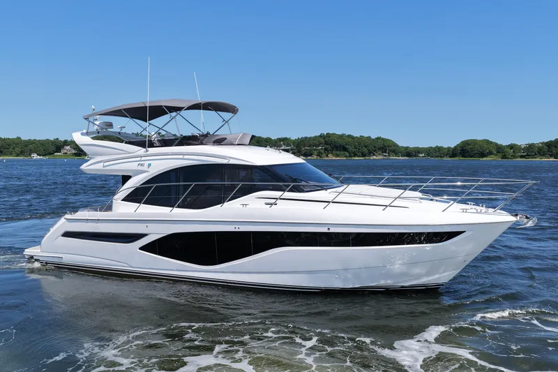 Slide: The Image of Luxurious 2027 Princess F50 yacht cruising on a serene lake under a clear blue sky. - 13