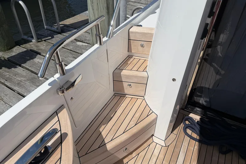Slide: The Image of Staircase on 2027 Princess F50 yacht with sleek wooden finish and stainless steel railing. - 27