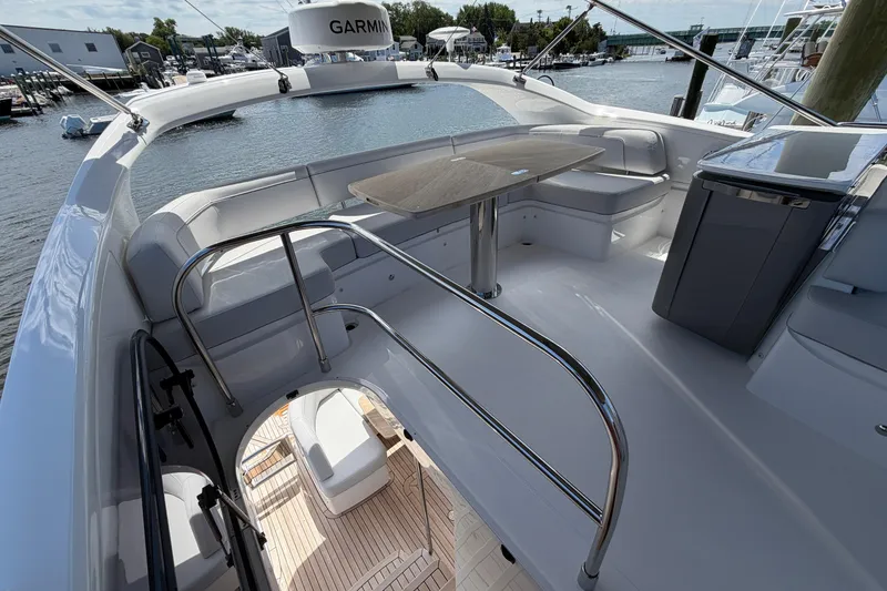 Slide: The Image of Luxurious 2027 Princess F50 yacht deck with seating and table, overlooking marina. - 49