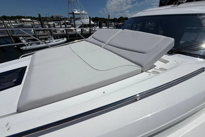 Slide: The Image of Luxurious sunbed on 2027 Princess F50 yacht, docked at marina under clear skies. - 46
