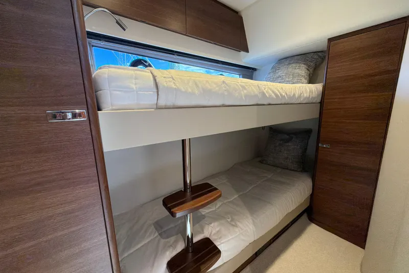 Slide: The Image of Bunk beds in a 2027 Princess F50 yacht cabin with wooden accents and modern design. - 108