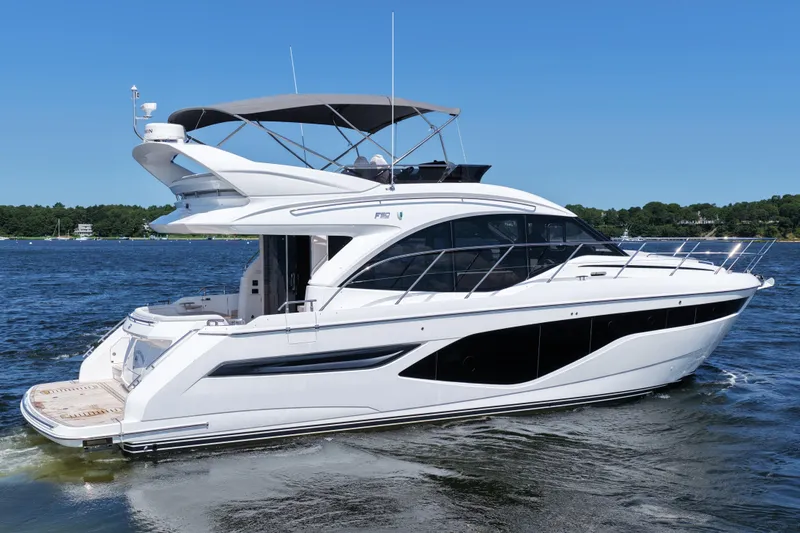 Slide: The Image of Luxury 2027 Princess F50 yacht cruising on a serene lake under clear blue skies. - 11
