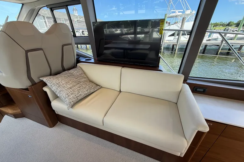 Slide: The Image of Luxurious interior of 2027 Princess F50 yacht with plush seating and scenic window view. - 84