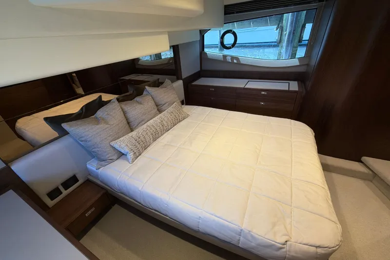 Slide: The Image of Luxurious bedroom interior of 2027 Princess F50 yacht with elegant bedding and wooden accents. - 115