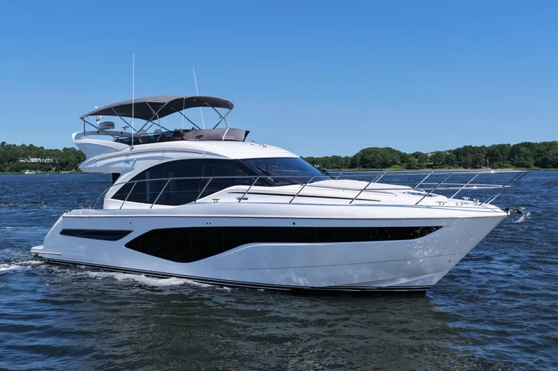 Slide: The Image of Luxurious 2027 Princess F50 yacht cruising on a serene lake under a clear blue sky. - 2