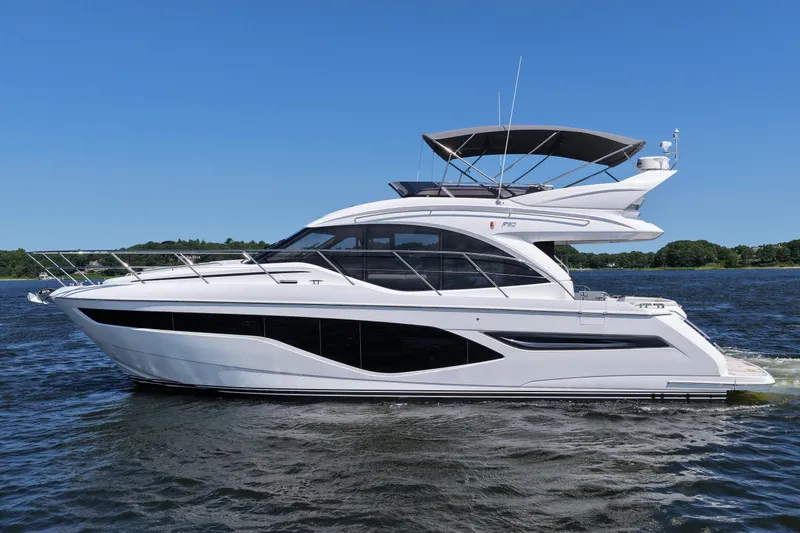Slide: The Image of Luxury 2027 Princess F50 yacht cruising on a serene lake under a clear blue sky. - 6