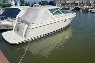 The Image of 1995 Tiara Express boat docked in a marina, covered and secured. - 0